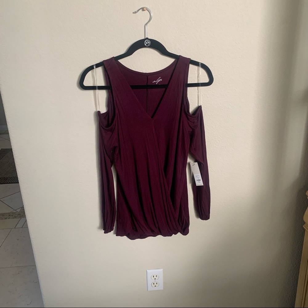 NWT Plum Shoulder Cut Off Blouse by Francesca. Size Small. Brand new!